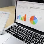 Laptop displaying charts and graphs with information on survey results