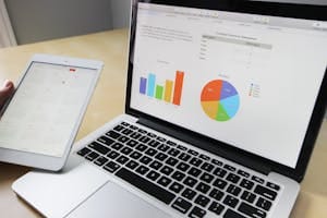 Laptop displaying charts and graphs with information on survey results